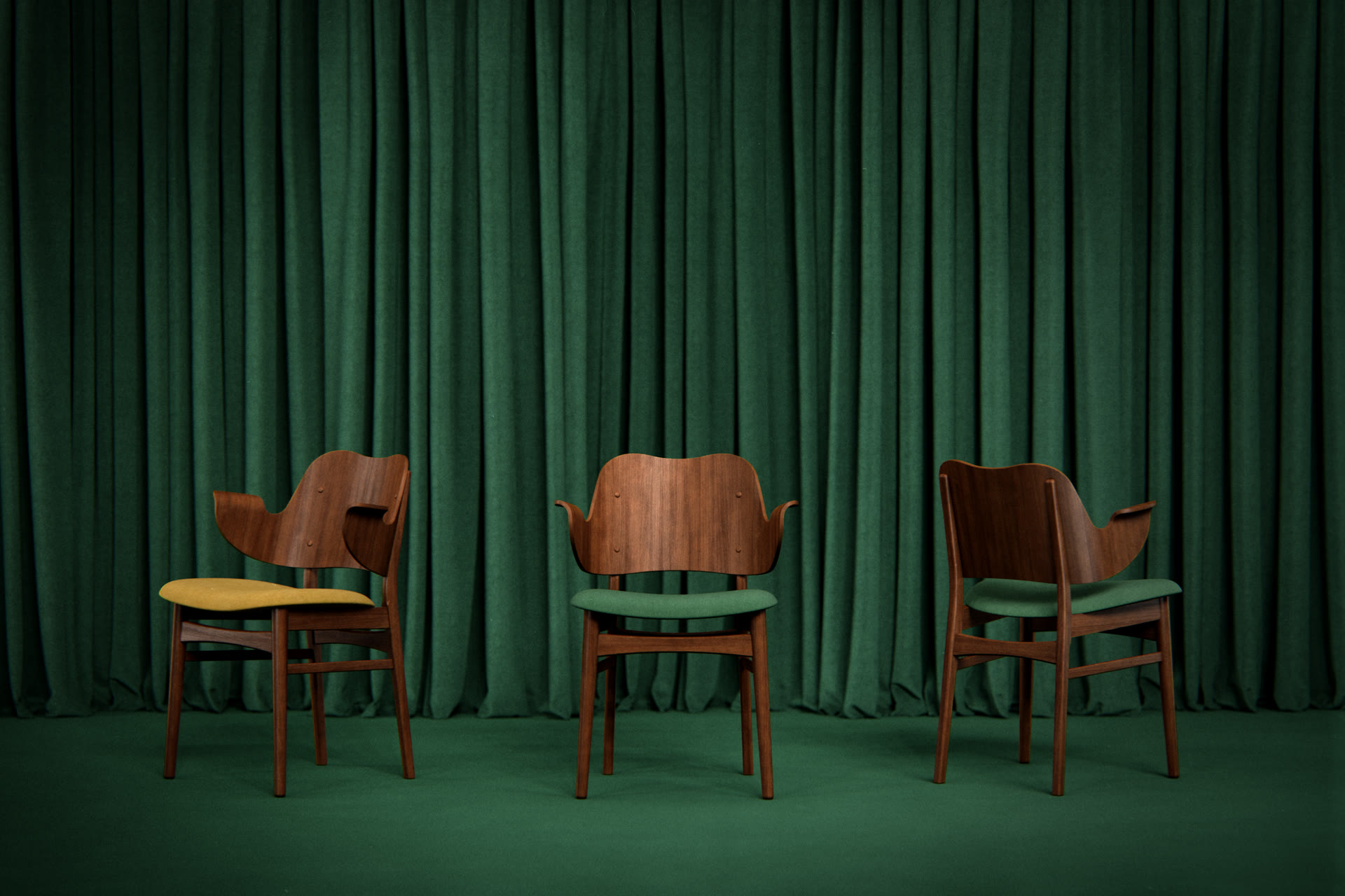 Three wooden armchairs with yellow and green upholstery, arranged on a green stage with a green curtain backdrop, architectural visualization