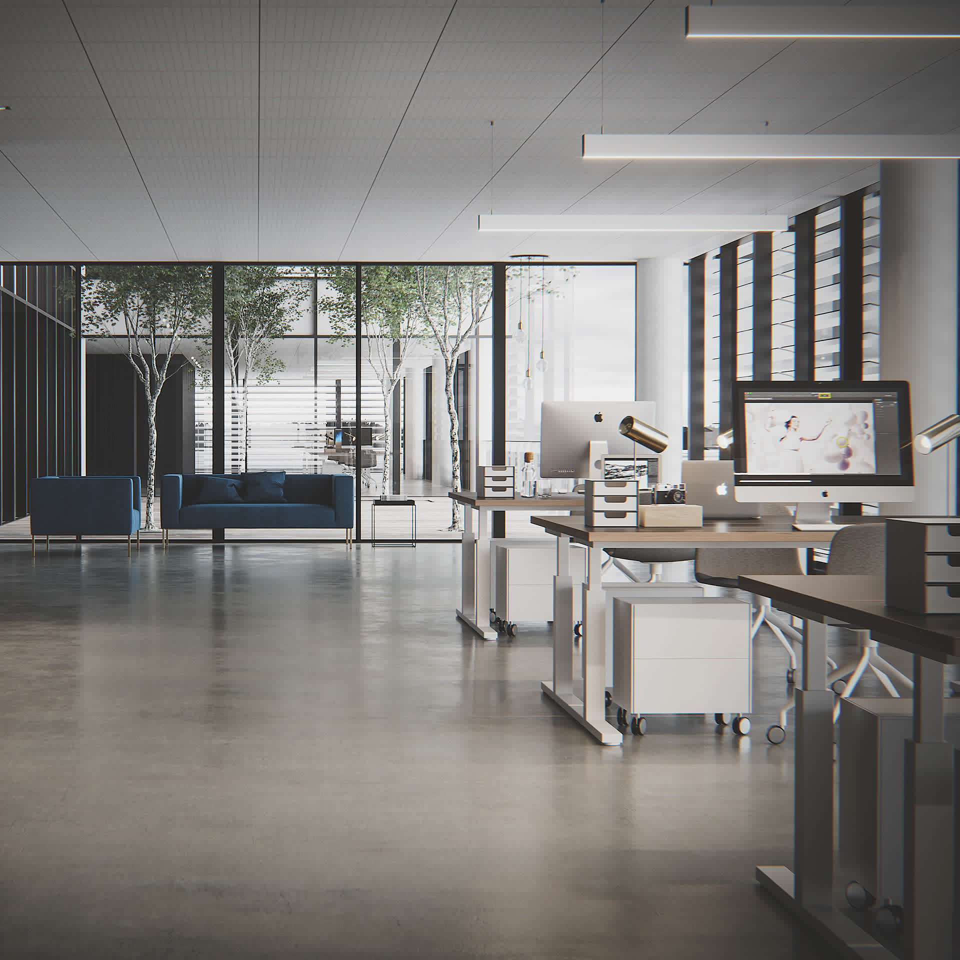 Open-plan office interior with standing desks, computer monitors and blue sofas, architectural visualization